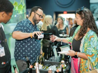 Wine tasting at Galveston Island Wine Festival with Moody Gardens backdrop